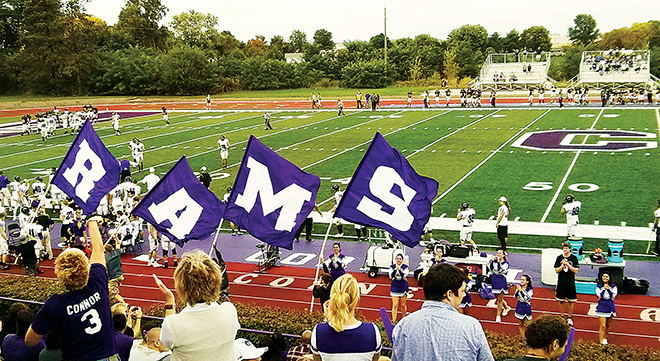 Ram football fans cheer from the stands at Van Metre Field at Ash Park.