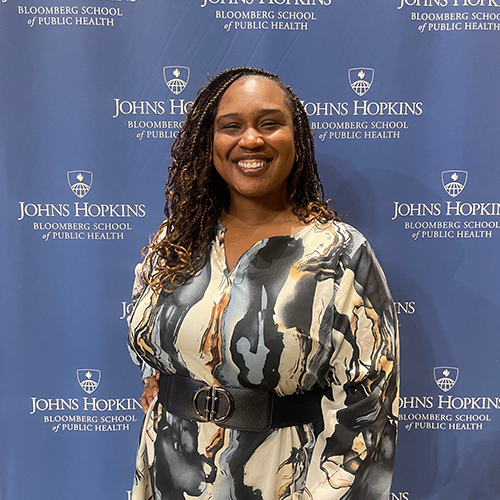 Angelica Hall '15 in front of the Johns Hopkins backdrop.