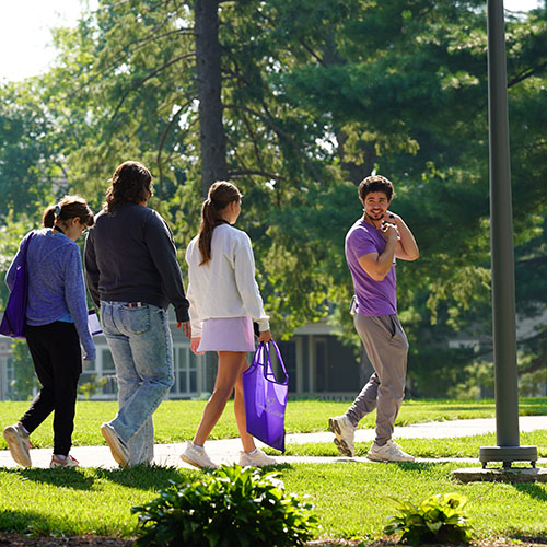 Student tour guide with event attendees on Ped Mall