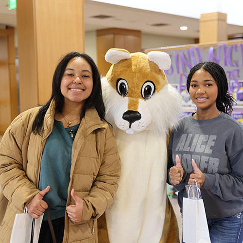 Students posing with Squirrel mascot